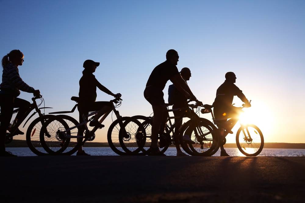 Image of sporty friends on bikes outside