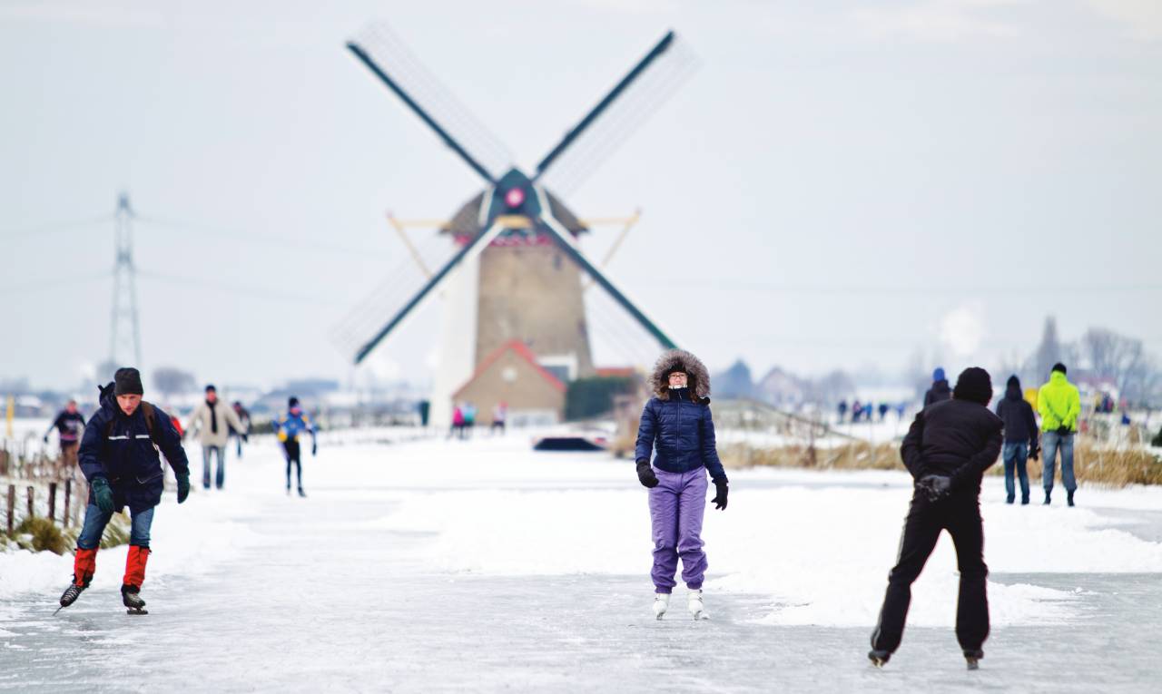 Ice skaters the Netherlands windmill