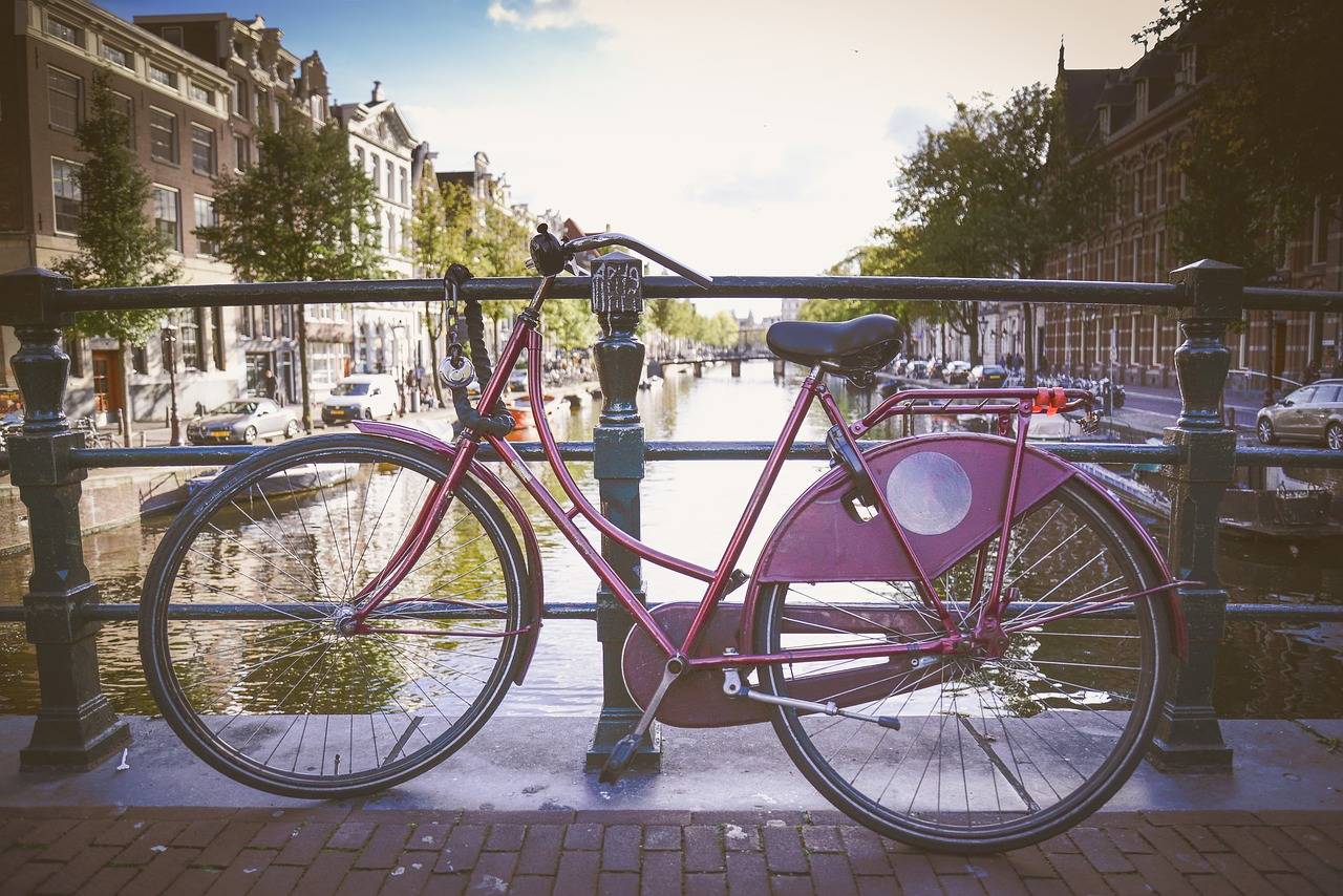 Purple Oma Fiets in Amsterdam on bridge