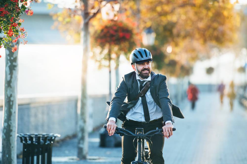Man cycling to work helmet suit