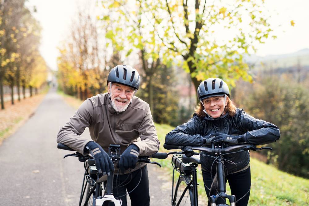 Couple riding E-bikes helmet