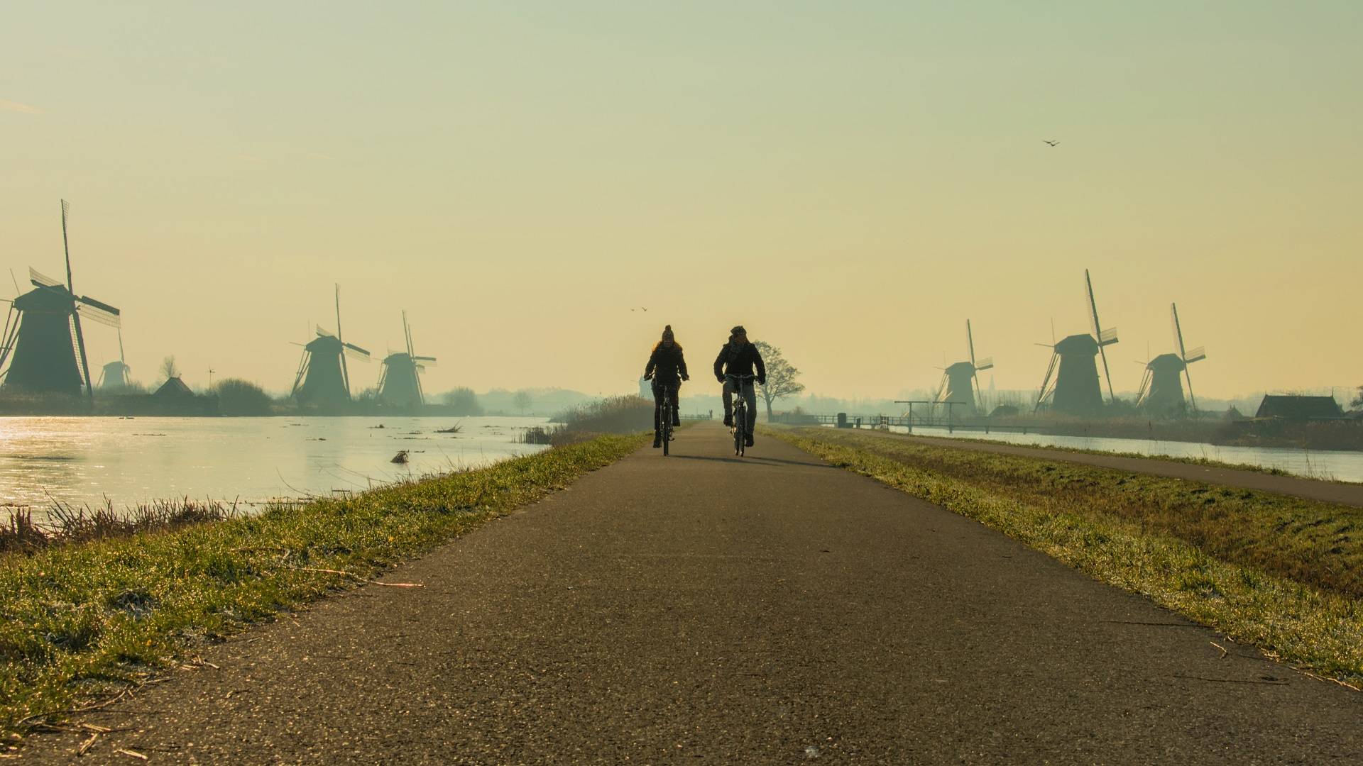 Couple riding Kinderdijk windmills_HDR